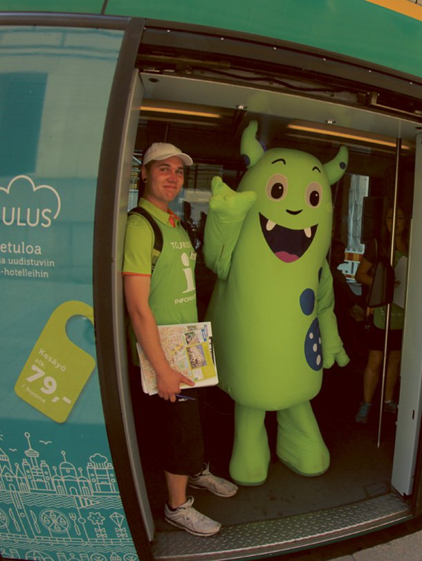 Helppi-hahmo auttaa turisteja Helsingissä.